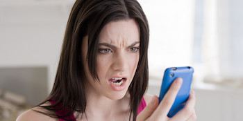 Angry woman looking at cellphone